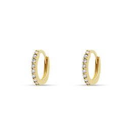 Our 14 karat gold huggie earrings feature handset diamond pave stones and are the ultimate essential for an every day sophisticated look.