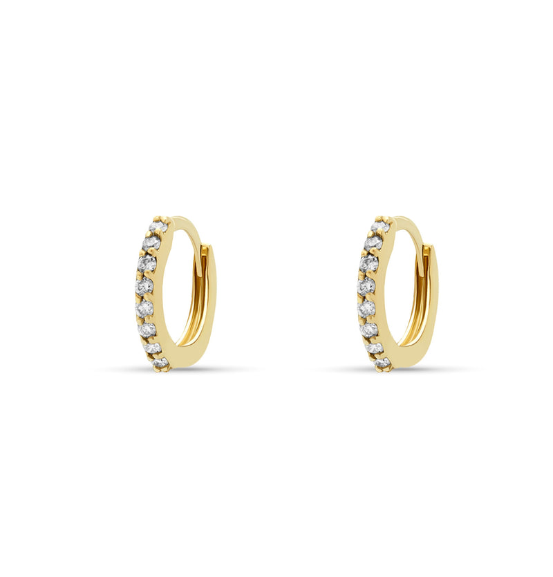Our 14 karat gold huggie earrings feature handset diamond pave stones and are the ultimate essential for an every day sophisticated look.