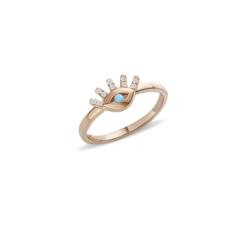 This 14 karat gold diamond ring is our dream jewelry piece. The turquoise stone in the center of the eye is encased with pave set diamond lashes. A magical gold ring that lasts a lifetime.