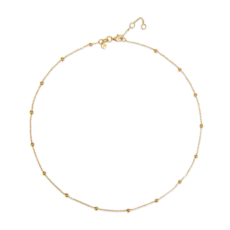 This ball chain necklace in 14 karat gold features petit balls aligned along the gold chain. Wear it by itself or combine with other gold necklaces for the ultimate layering look.