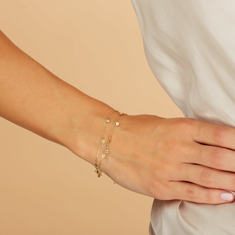 This double chain 14 karat gold ankle bracelet is one of our bestsellers!  The double chain anklet with all its shimmer, colours and little charms will accompany you with every step you take.