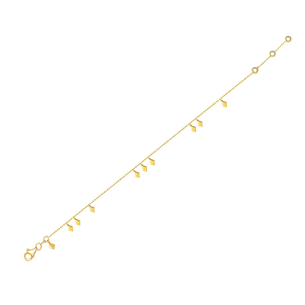This delicate and playful 14 karat gold bracelet features dangling tribal gold charms. Its simple style mixes and matches easily with other jewels and is the perfect accessory for a boho- glam look.