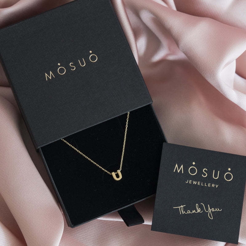 A 18 karat gold vermeil necklace with your initial letter "U". This diamond letter necklace is a special gold necklace that can be worn day and night. A genuine diamond stone in the corner of the letter makes this gold diamond necklace a luxury and ideal gift for yourself, your best friend or loved one.