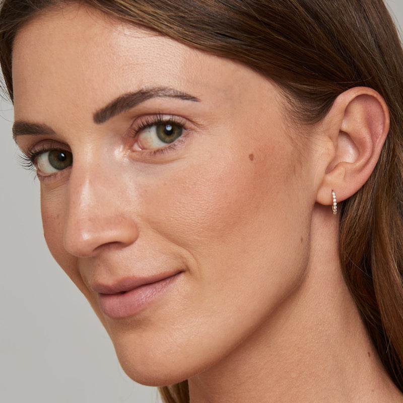 Our dazzling 14 karat gold charms for hoops feature the turquoise evil eye embodied in diamonds. Wear these charms on our Diamond Huggies or Essential Hoops for an extra dose of sparkle. 