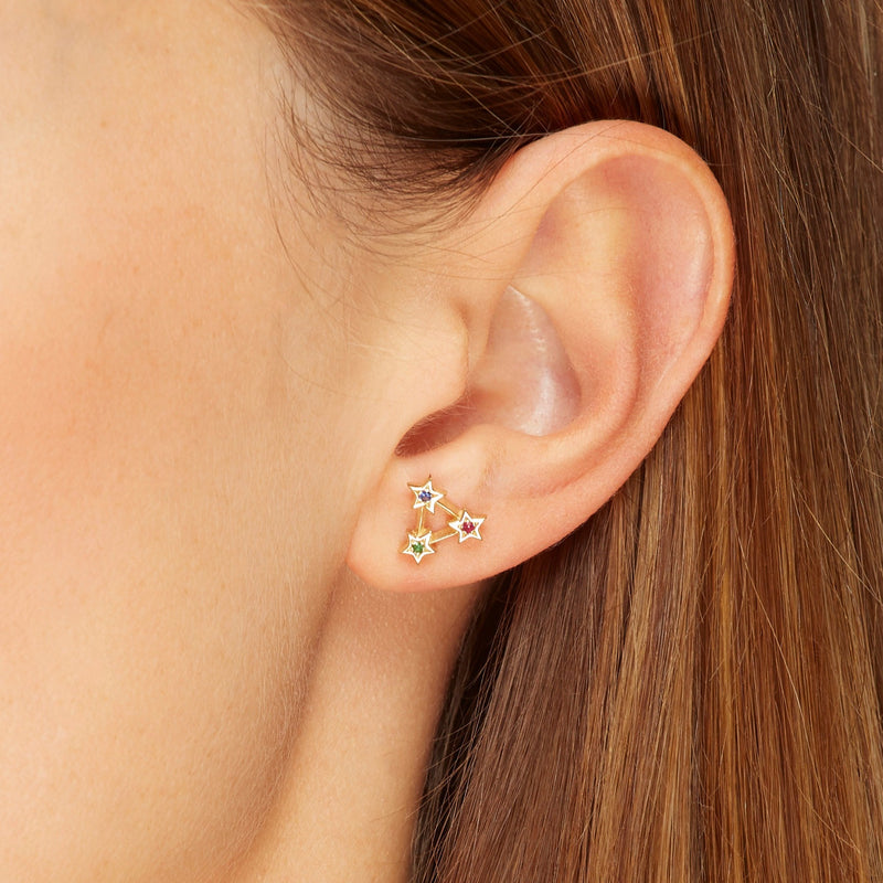 14 karat gold earrings with handset gemstones. Our Rainbow Star Stud Earrings are inspired by warm nights of star gazing. The emerald, sapphire and ruby stones add a playful glow to your eargame.